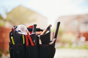 bag-of-tools-with-home-in-the-background