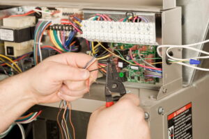 technicians-hands-working-with-furnace-wires
