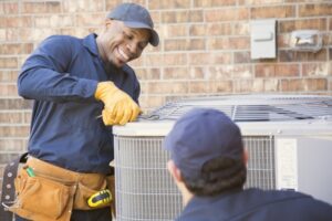two-technicians-working-outside-on-ac-unit